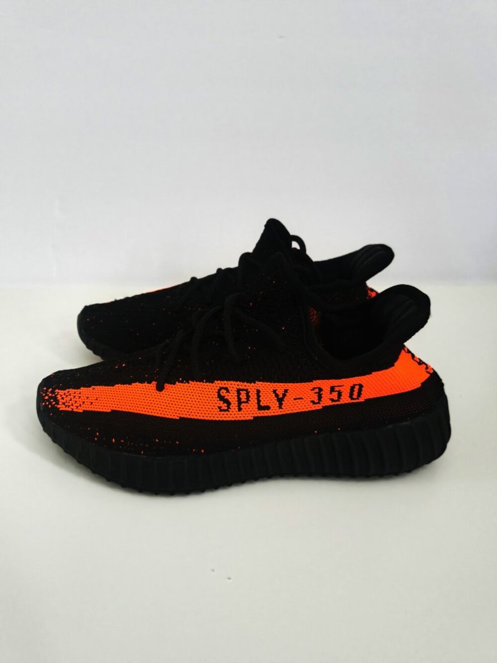 adidas men's Yeezy Boost 350 Black and Red Stripe Sneaker
